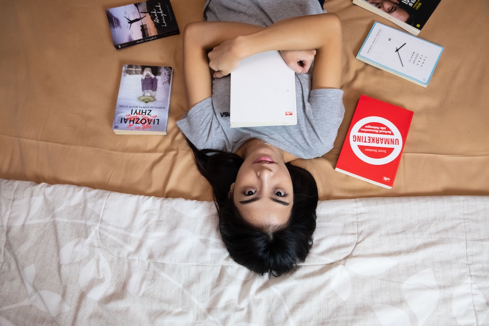 Woman of color hugging books (Model Syvi Melodi Oktavia)