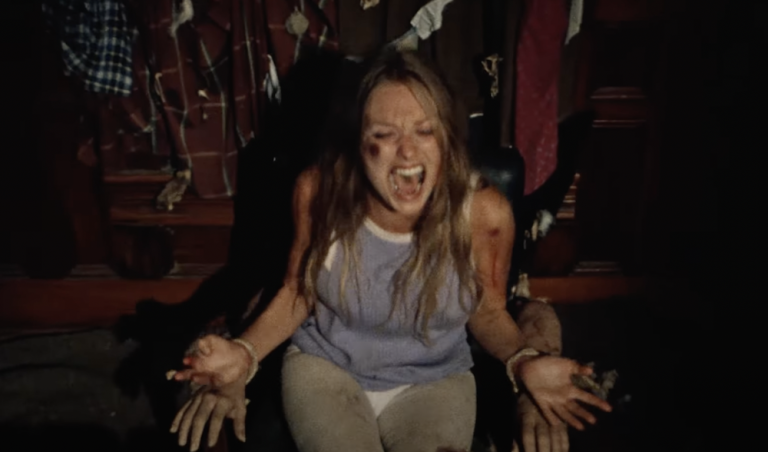 A woman screaming with blood on her body